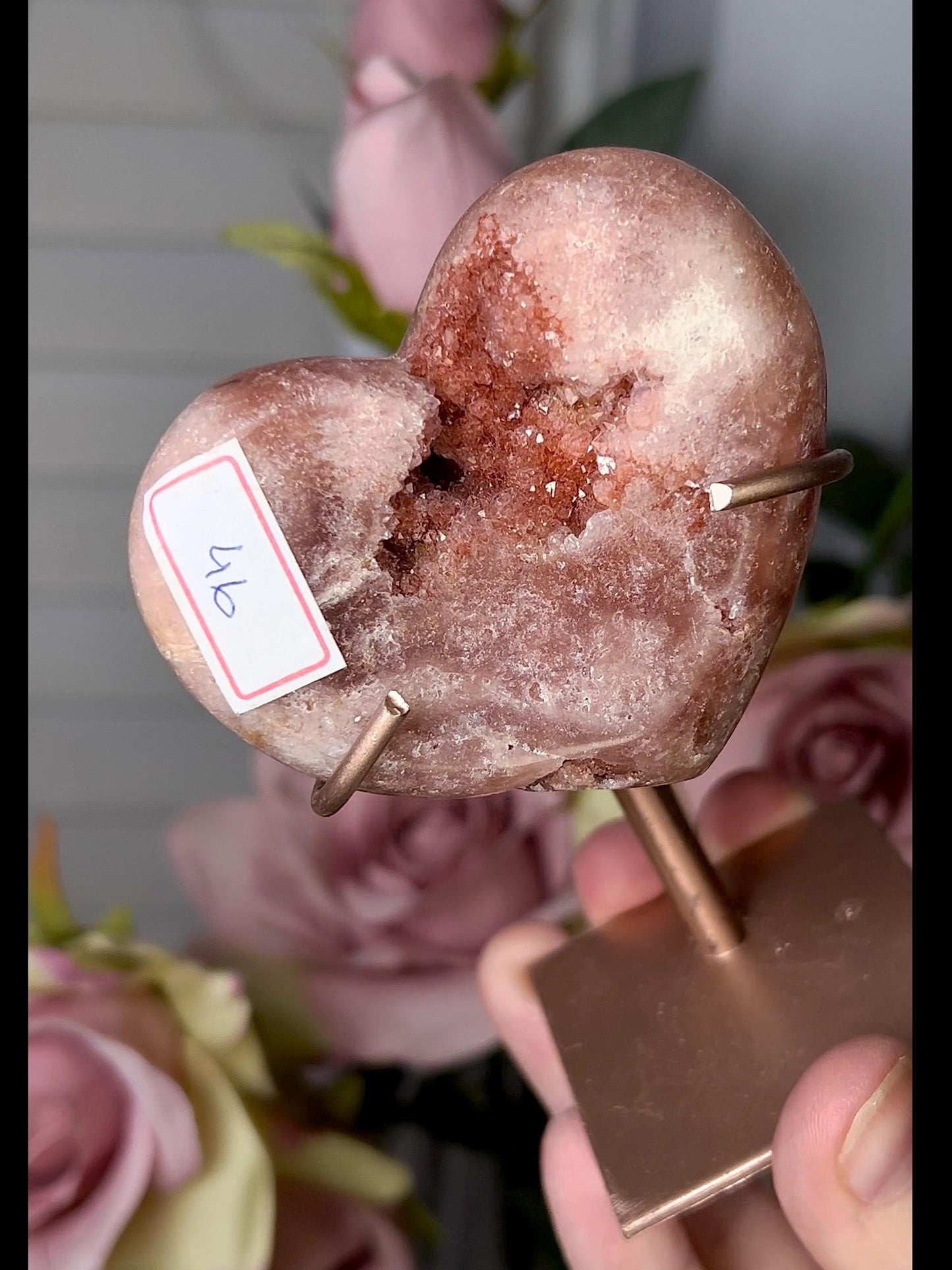 Beautiful, pink amethyst heart in a red tone with stand