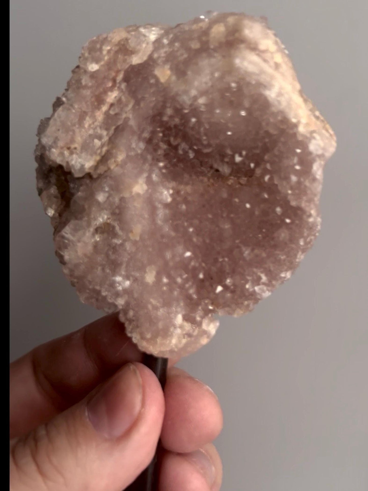 pink amethyst geode on stand