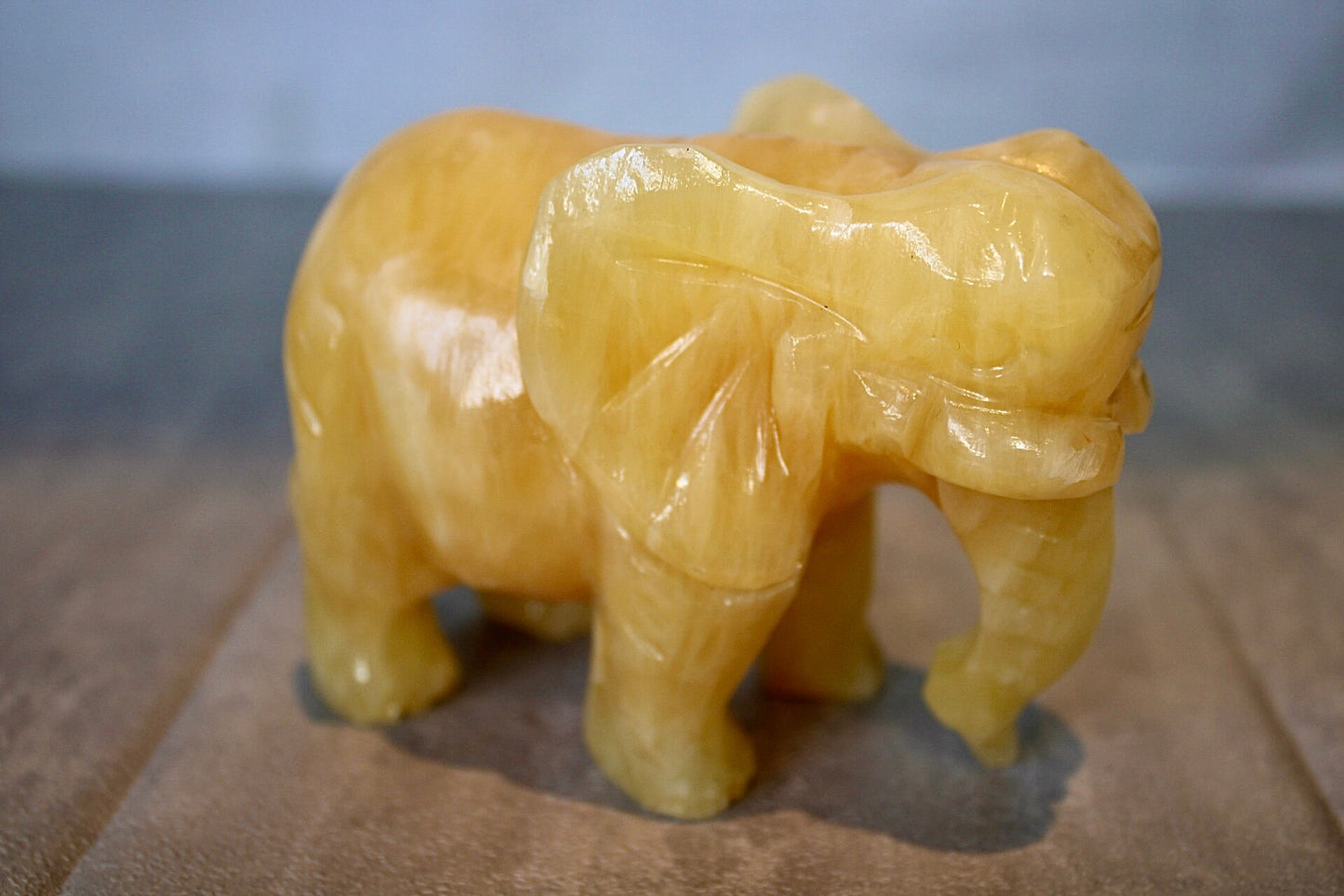 Large, orange calcite elephant carving 8cm(H) 10cm(L)