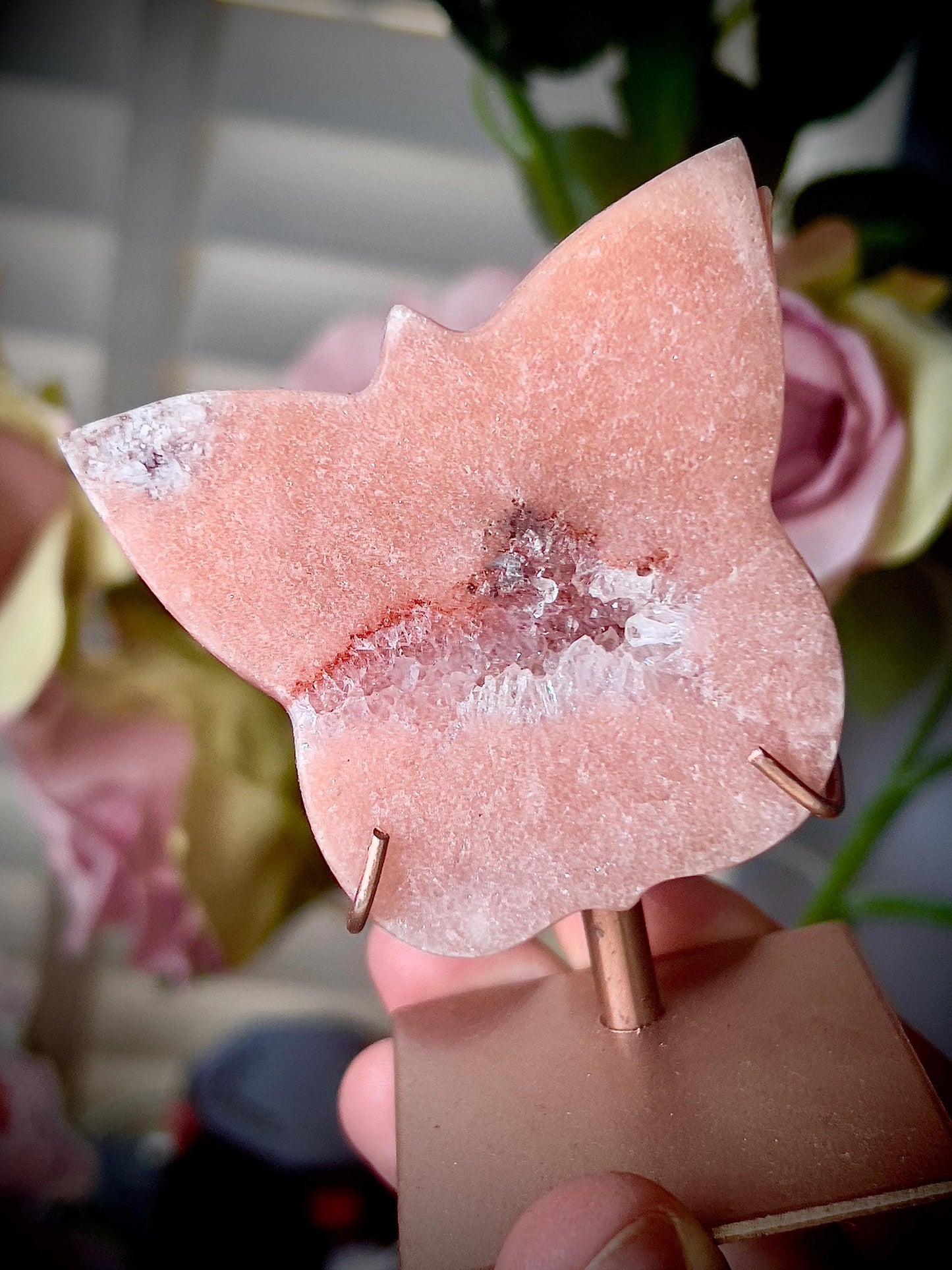 Pink amethyst butterfly in a peach tone with quartz middle and rutile edging, comes with stand