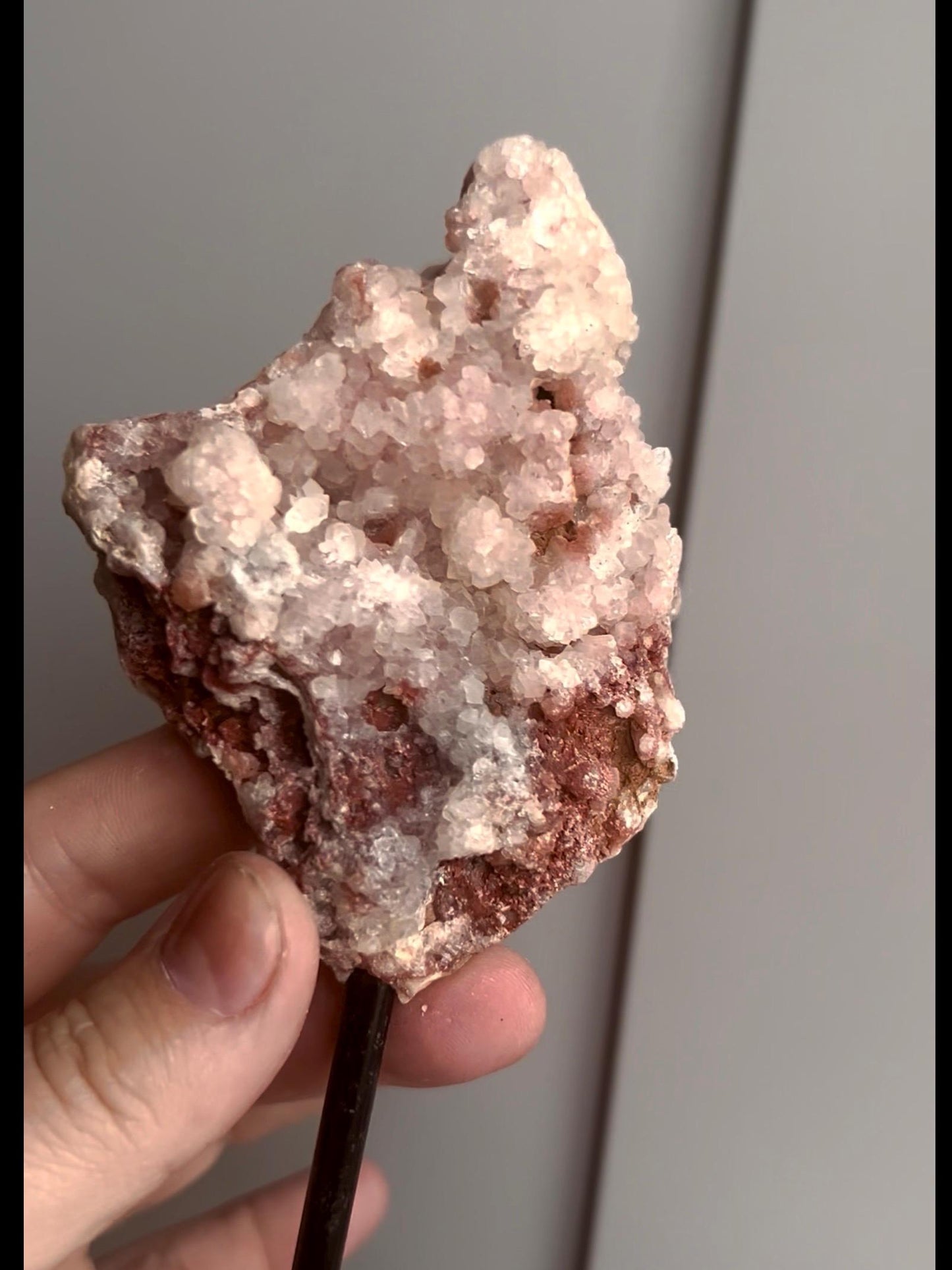Pink amethyst geode on stand