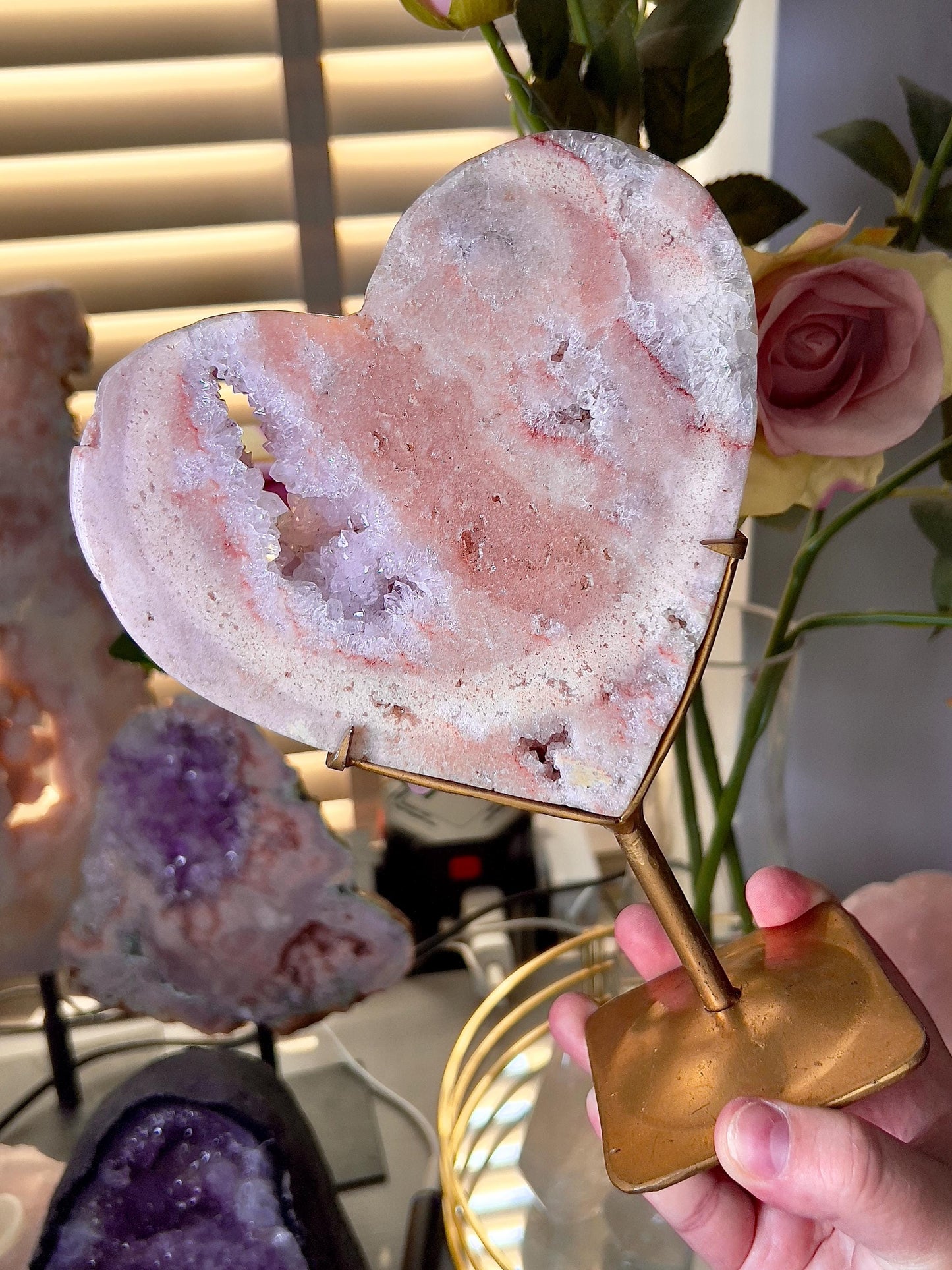 High quality, peach toned, pink amethyst heart with high drape quartz & red hematite lining on a custom gold stand 1.274kg