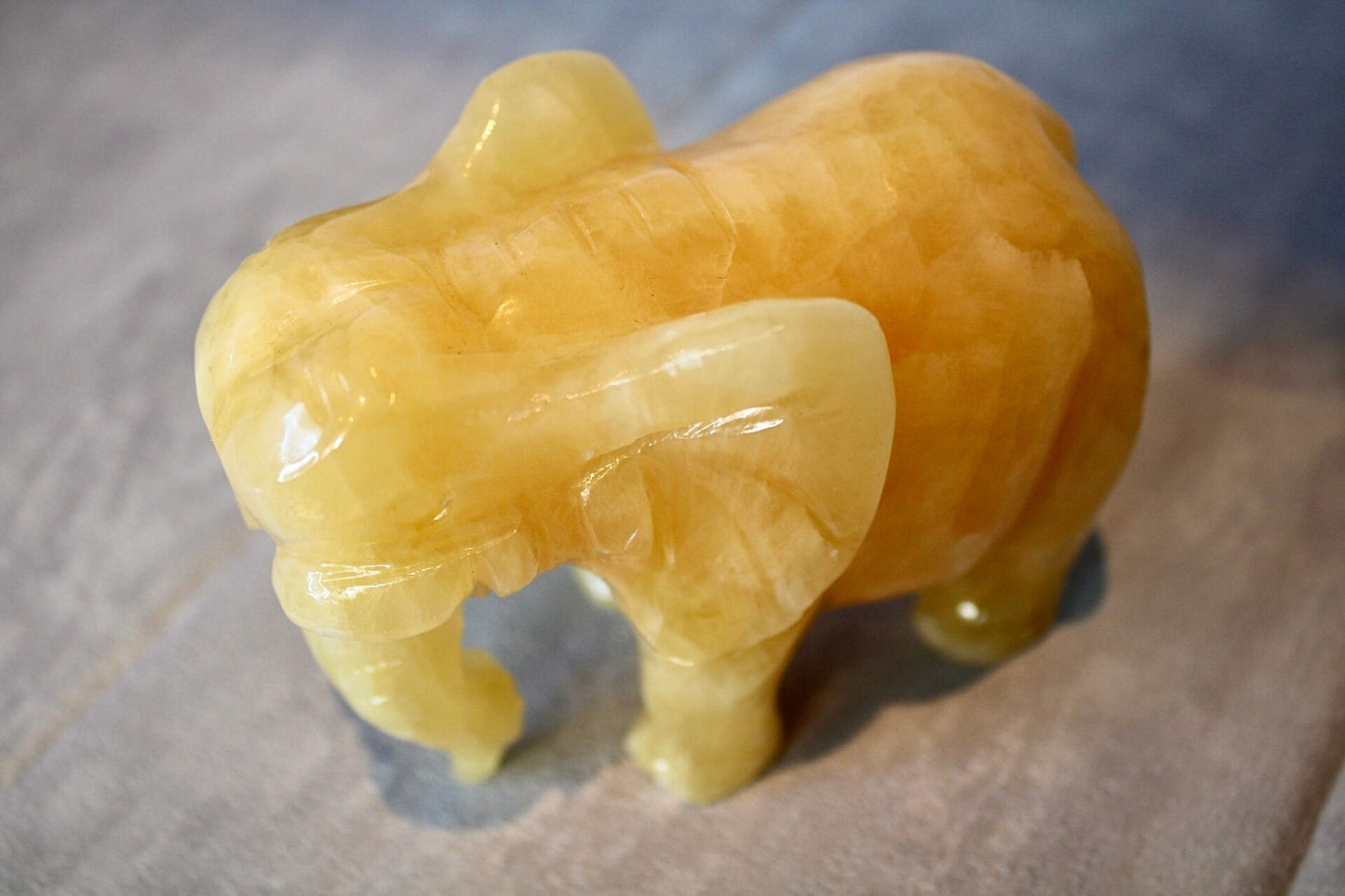 Large, orange calcite elephant carving 8cm(H) 10cm(L)