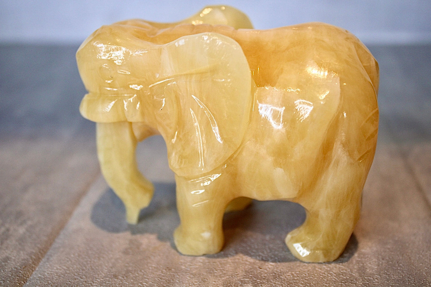 Large, orange calcite elephant carving 8cm(H) 10cm(L)