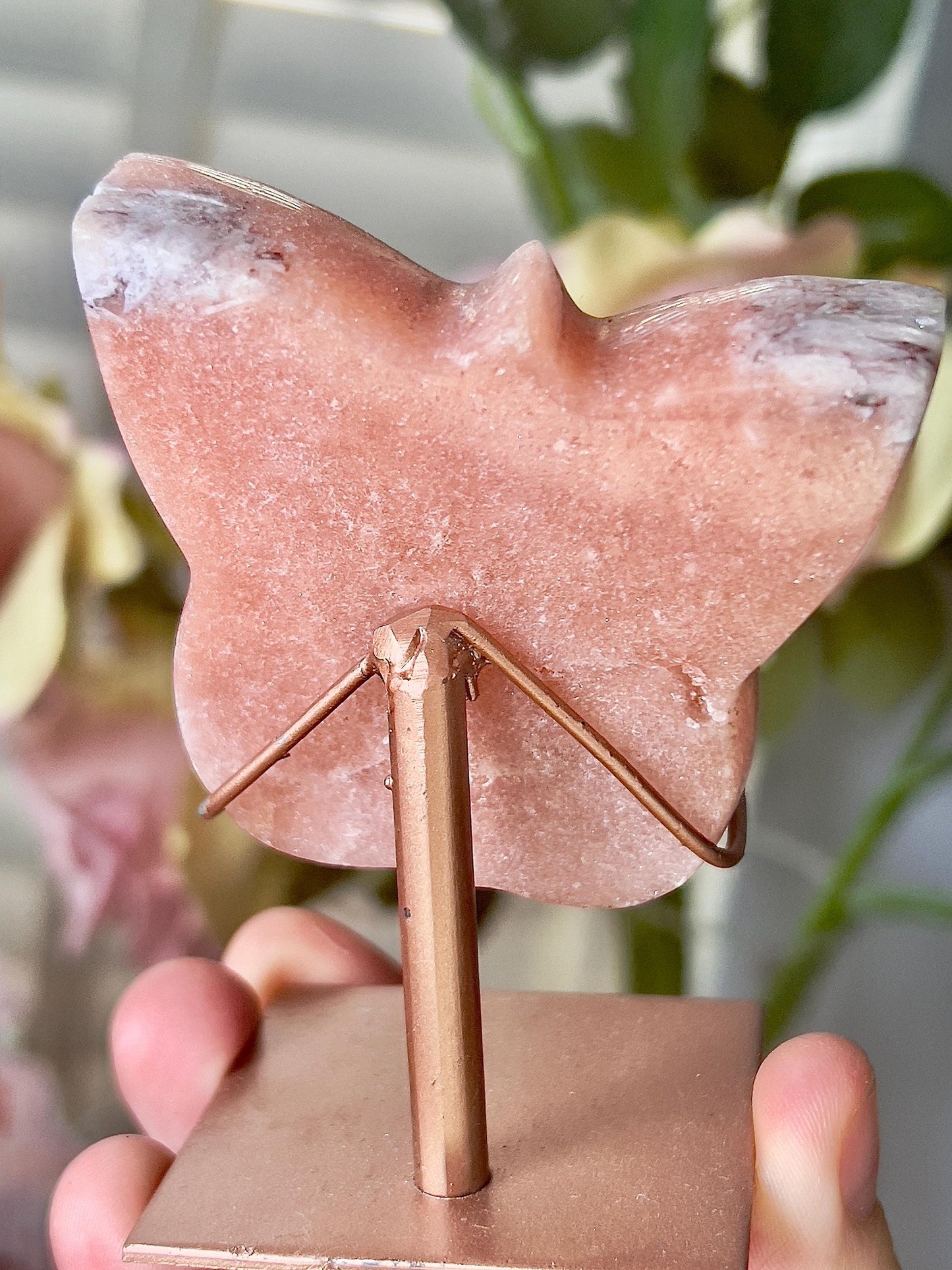 Pink amethyst butterfly in a peach tone with quartz middle and rutile edging, comes with stand