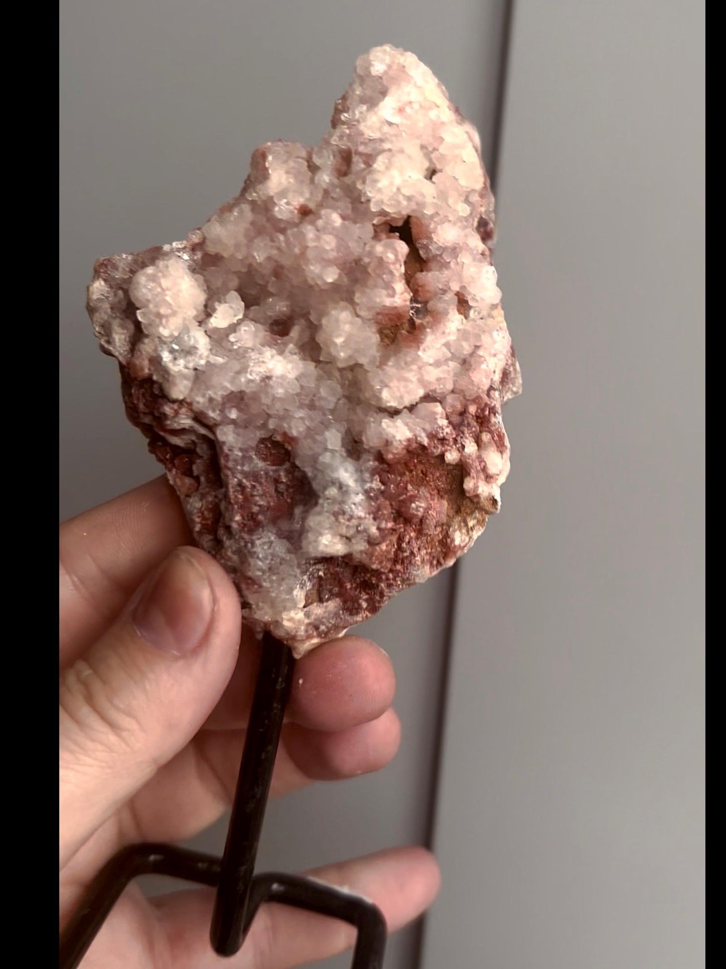 Pink amethyst geode on stand