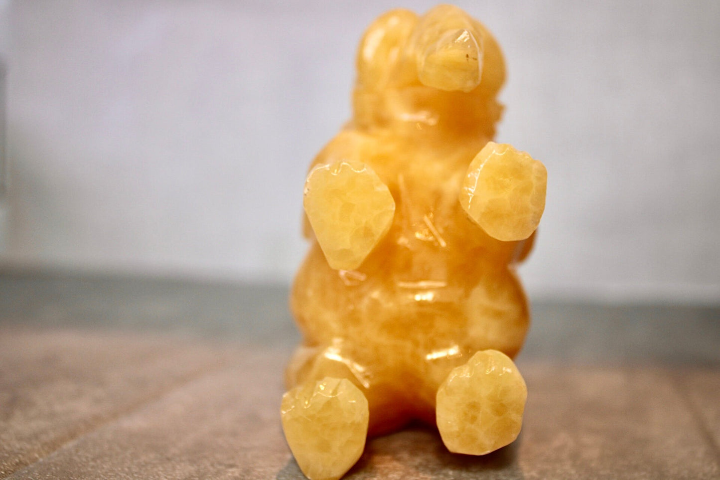 Large, orange calcite elephant carving 8cm(H) 10cm(L)