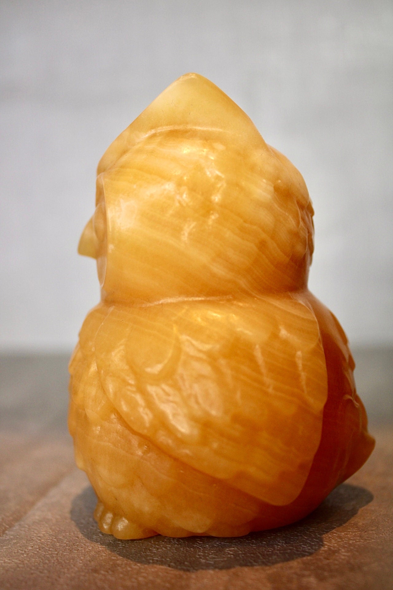 Large, orange calcite, owl carving 10cm(h) 8cm(w)