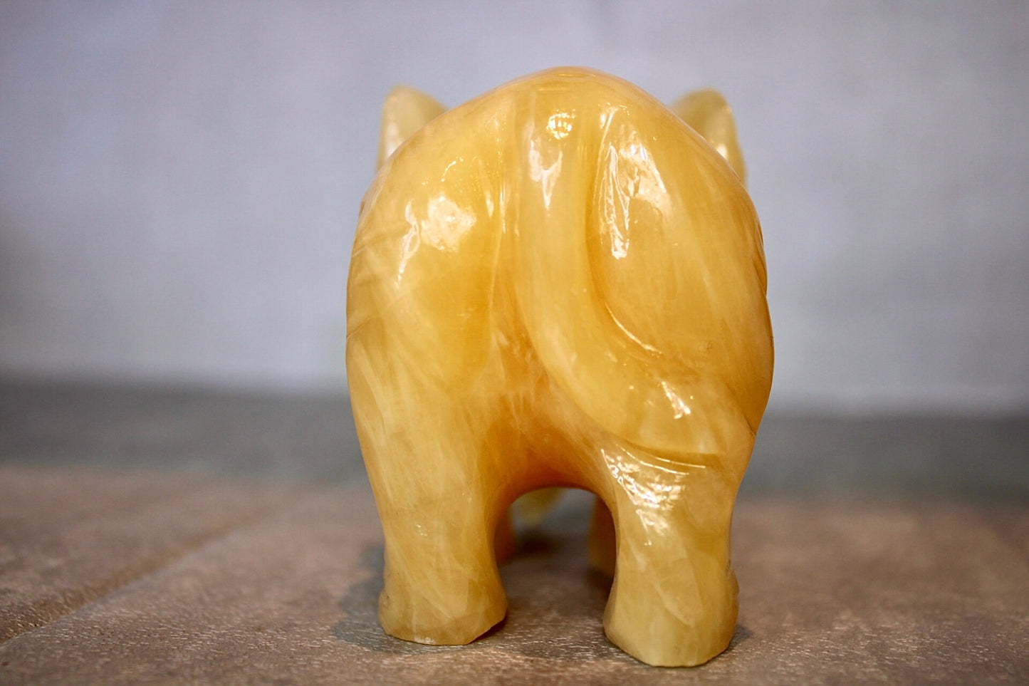 Large, orange calcite elephant carving 8cm(H) 10cm(L)