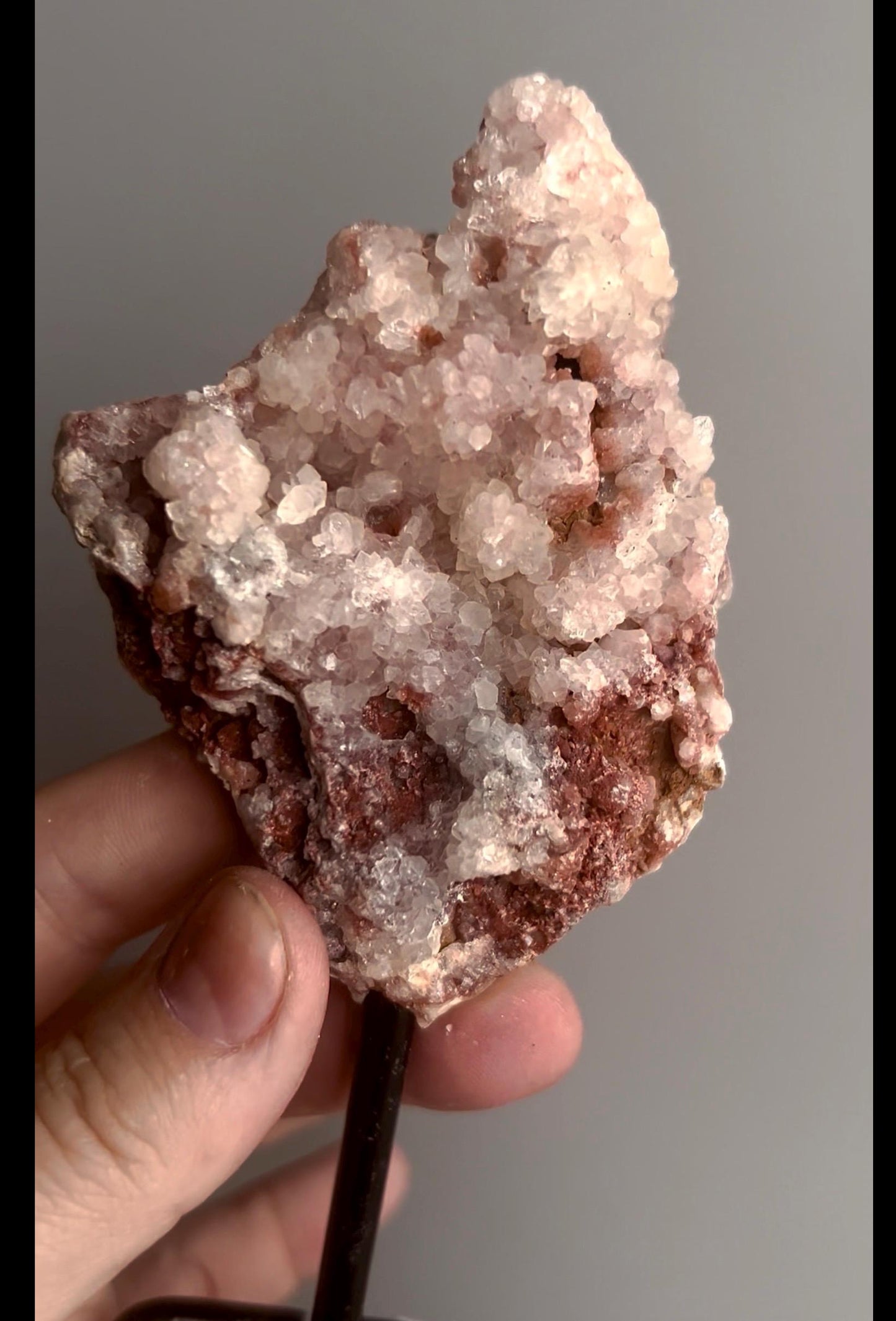 Pink amethyst geode on stand