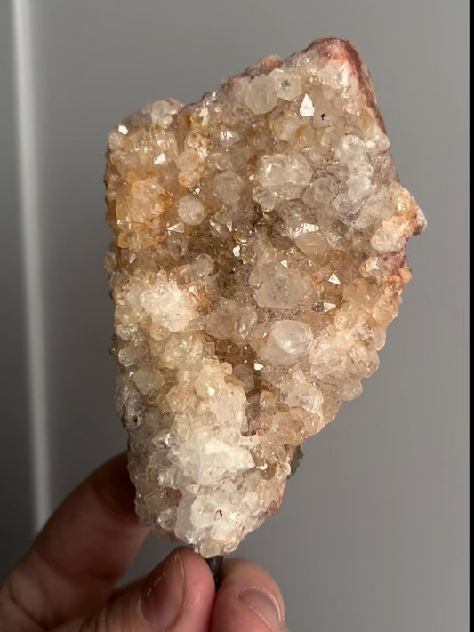 High grade, pink amethyst geode on stand with high clarity quartz teeth