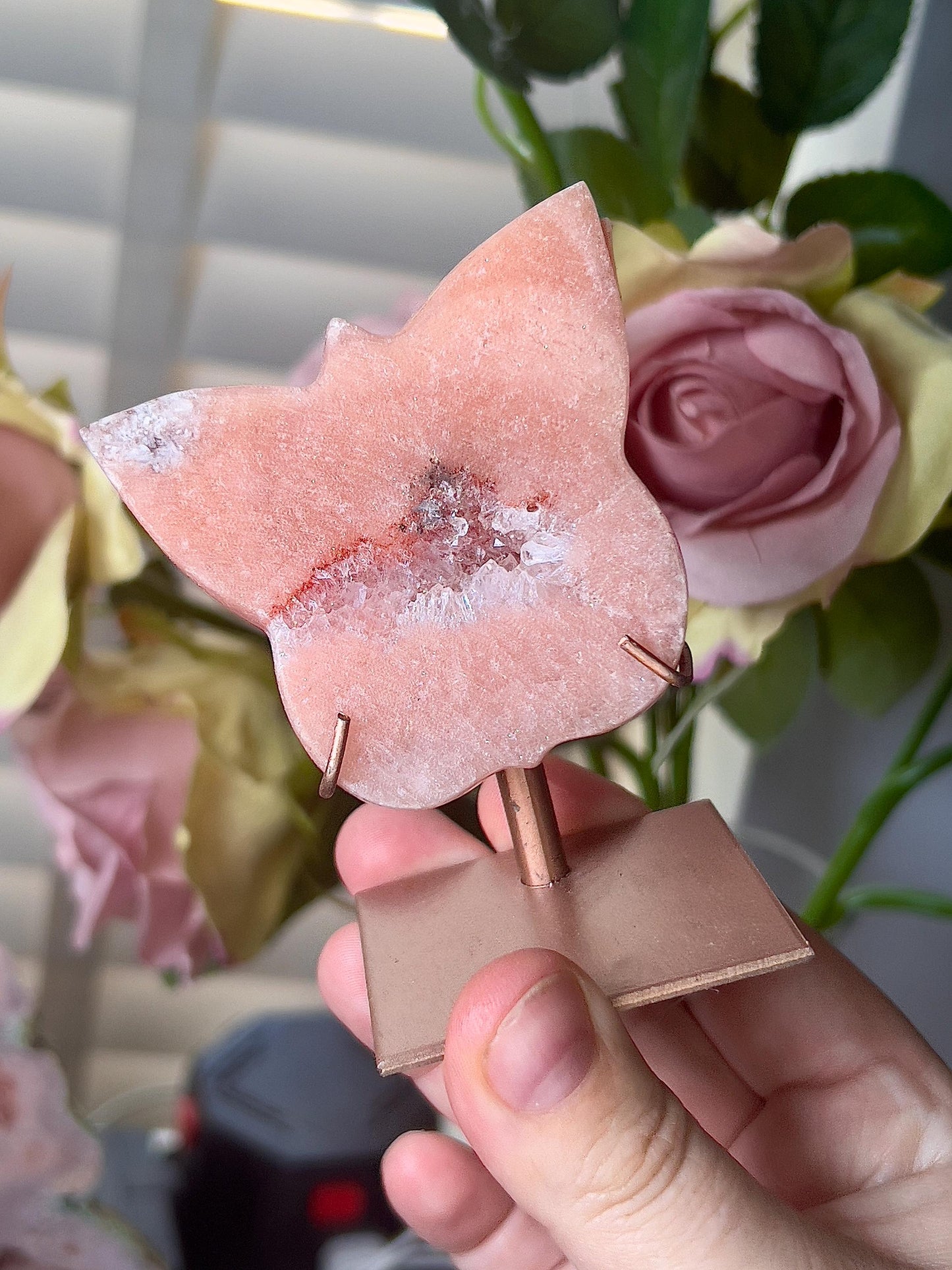 Pink amethyst butterfly in a peach tone with quartz middle and rutile edging, comes with stand