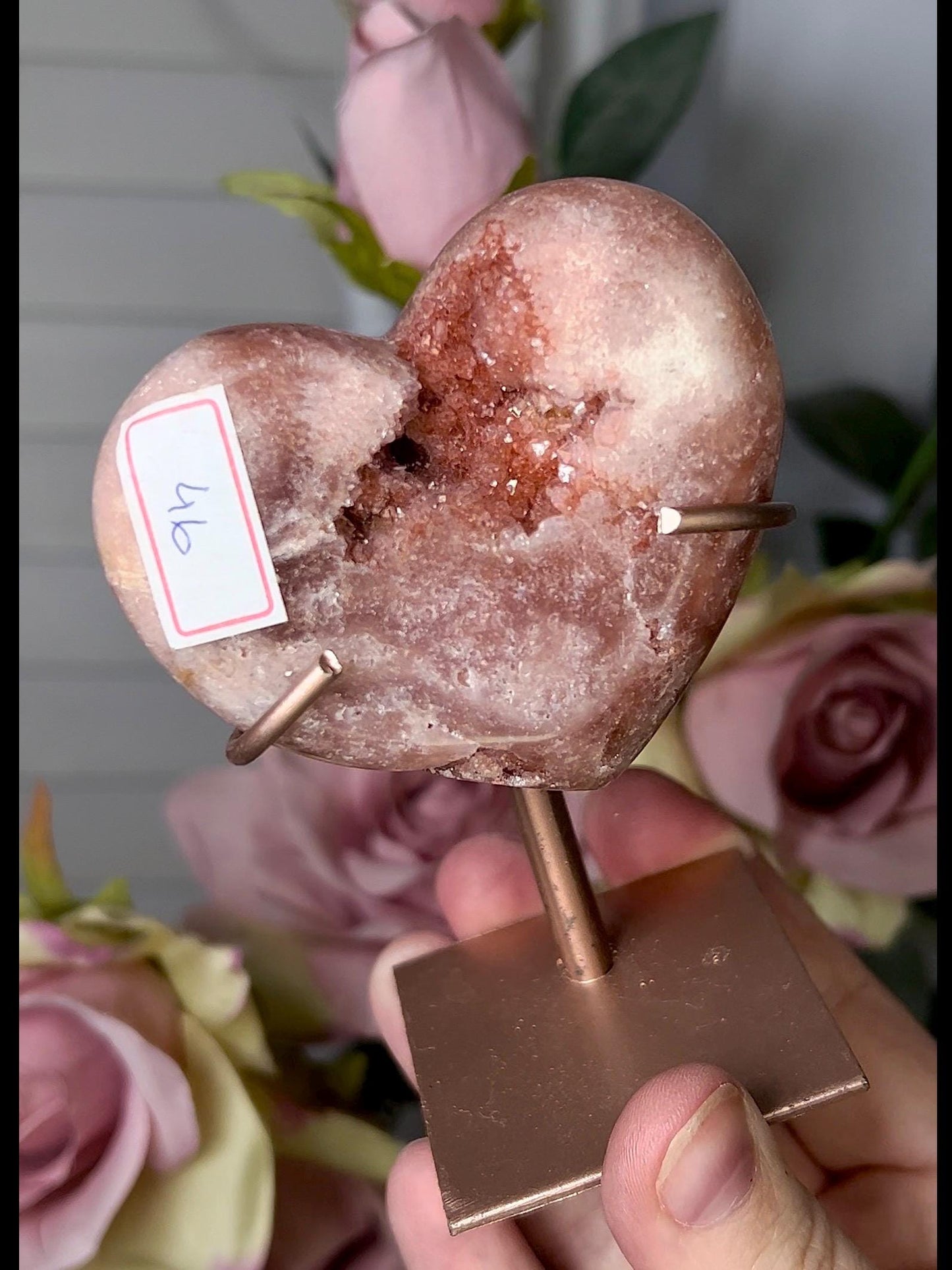 Beautiful, pink amethyst heart in a red tone with stand