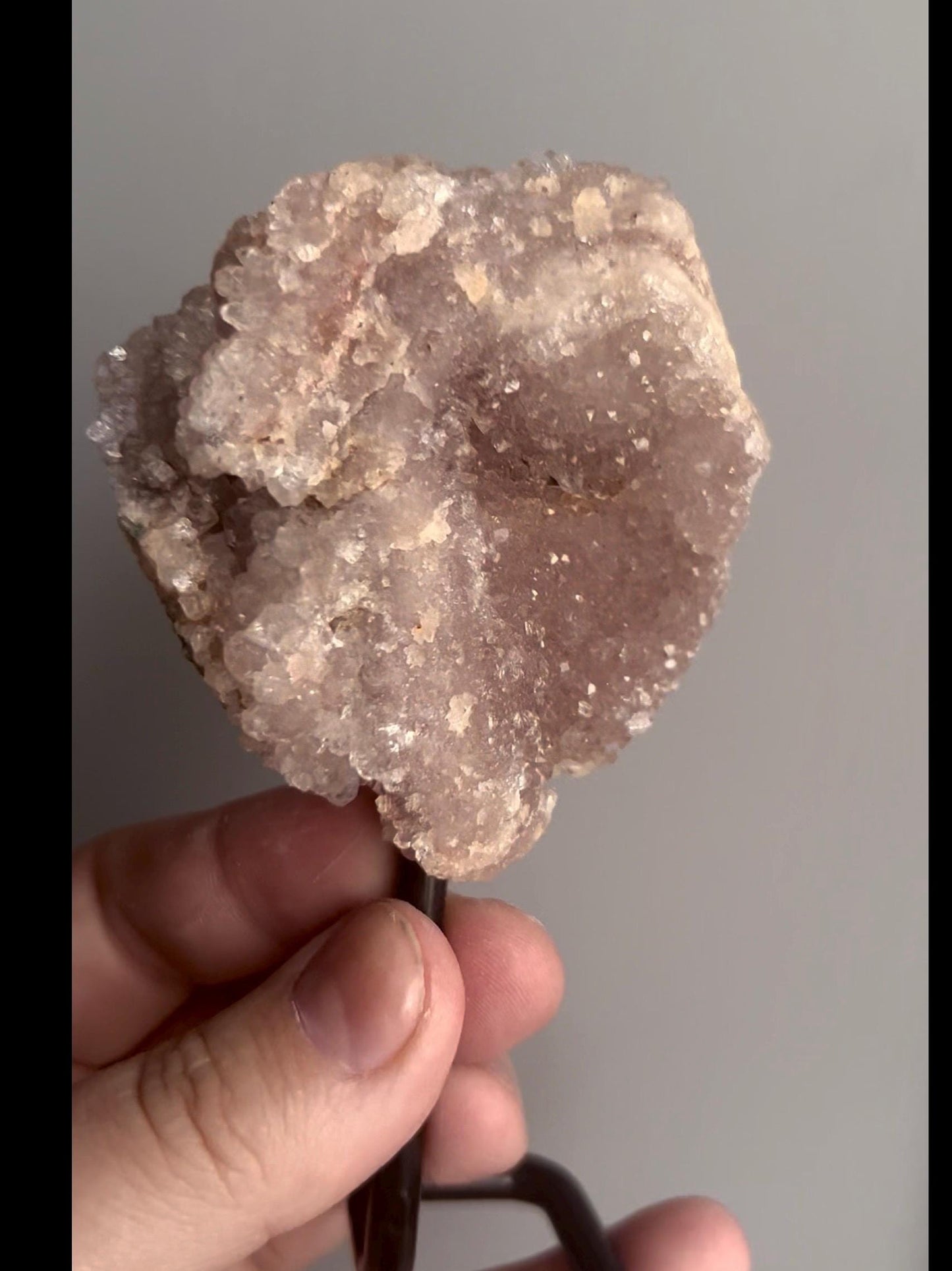 pink amethyst geode on stand