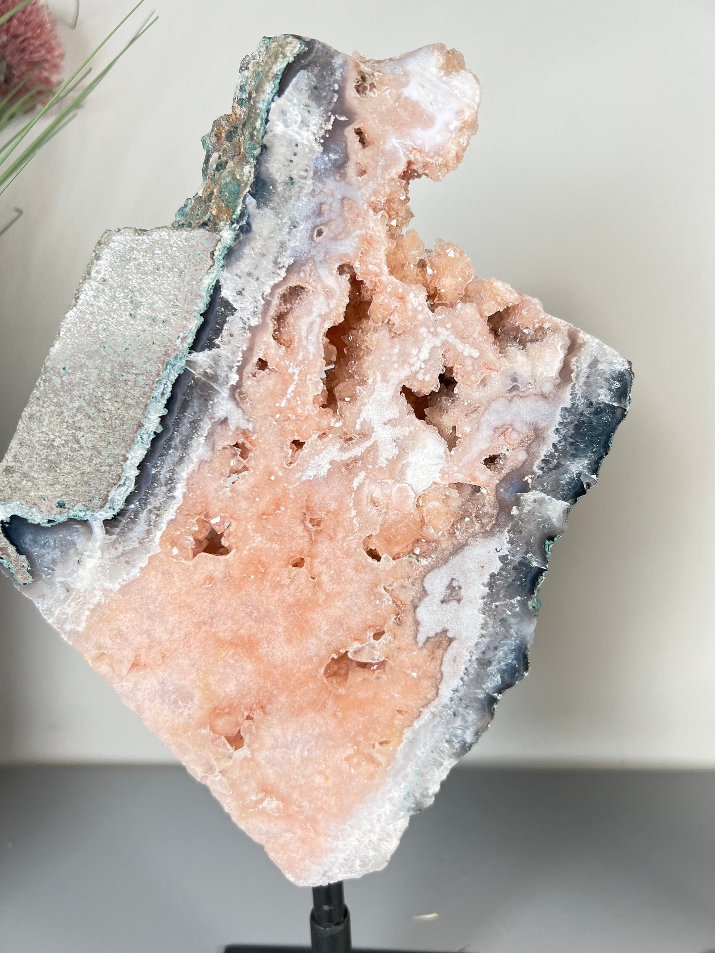 Gorgeous, peach, pink amethyst with smoky crystallisation and natural stone edging slab on turntable stand