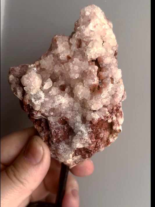 Pink amethyst geode on stand