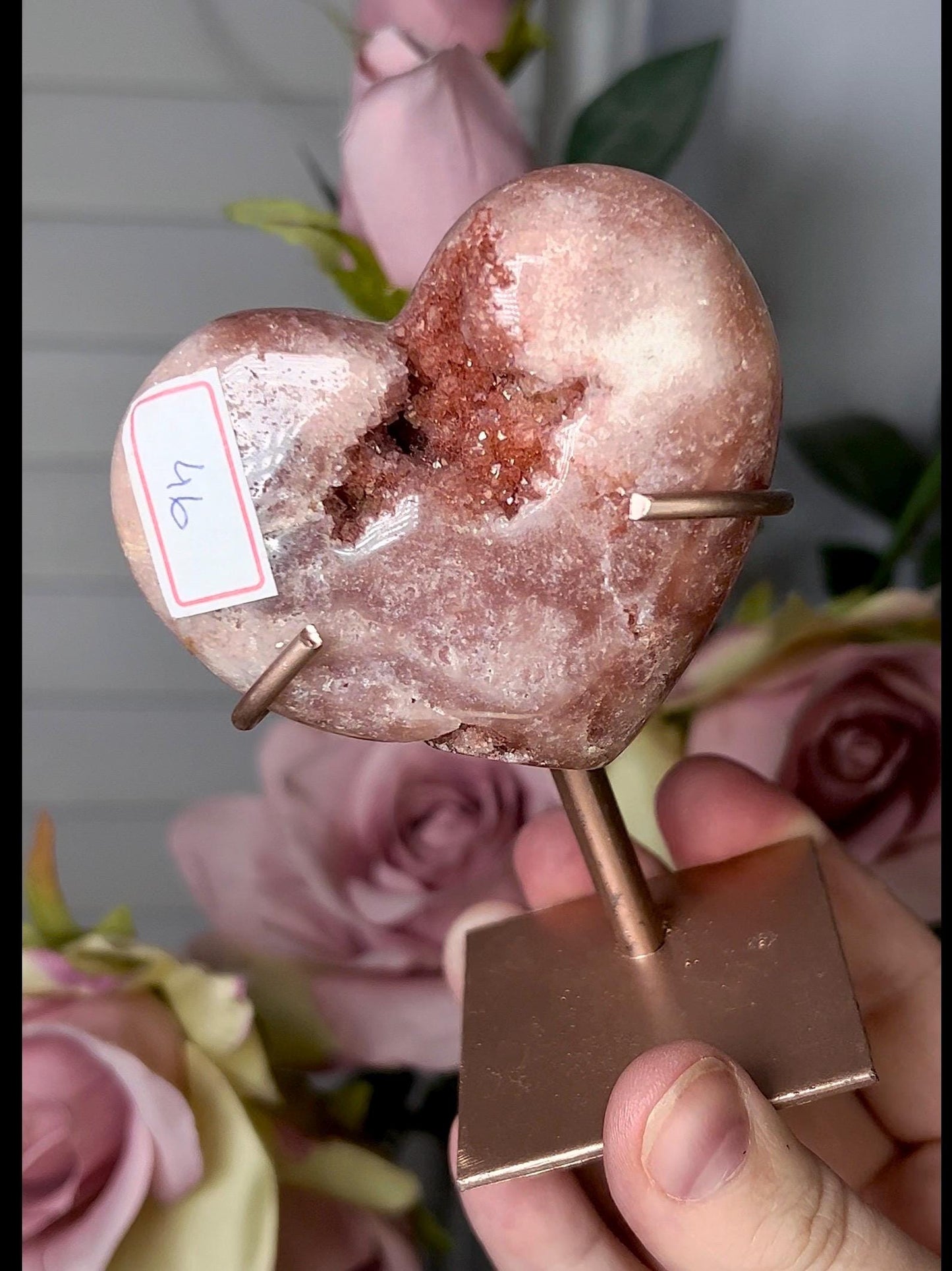 Beautiful, pink amethyst heart in a red tone with stand