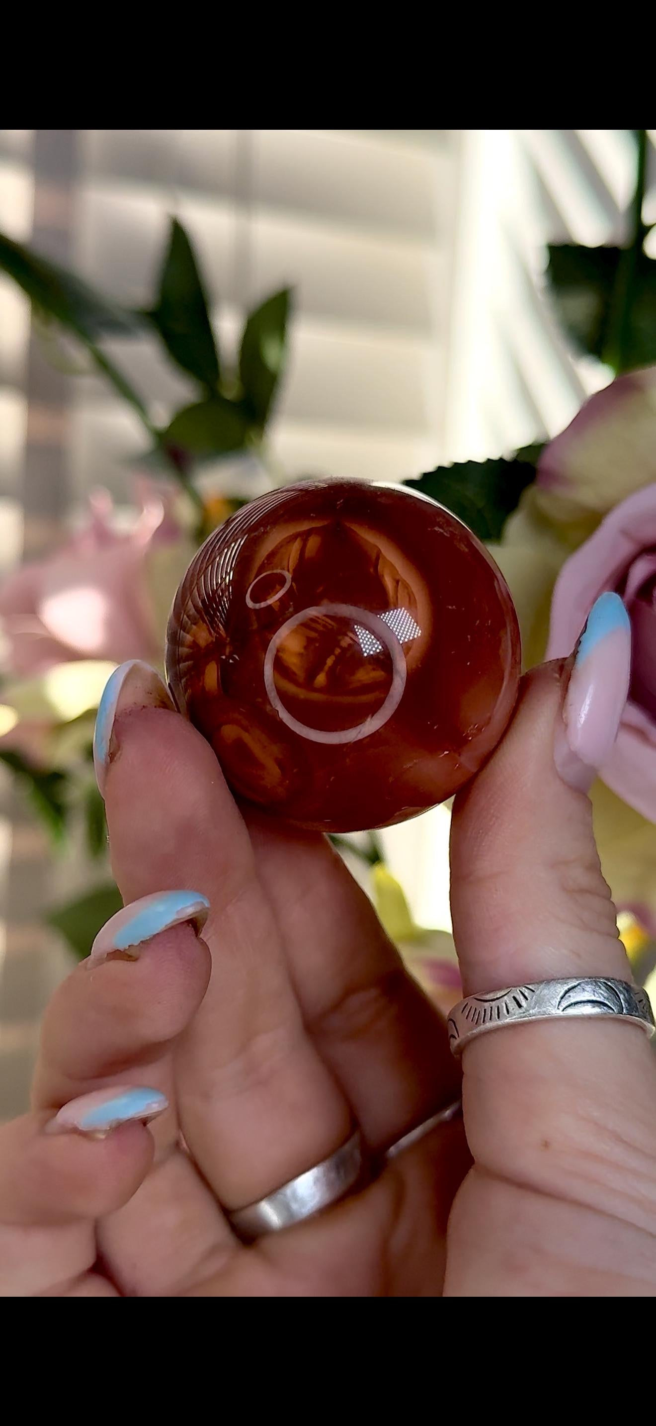 High quality, small red agate, carnelian sphere in orange/red tones