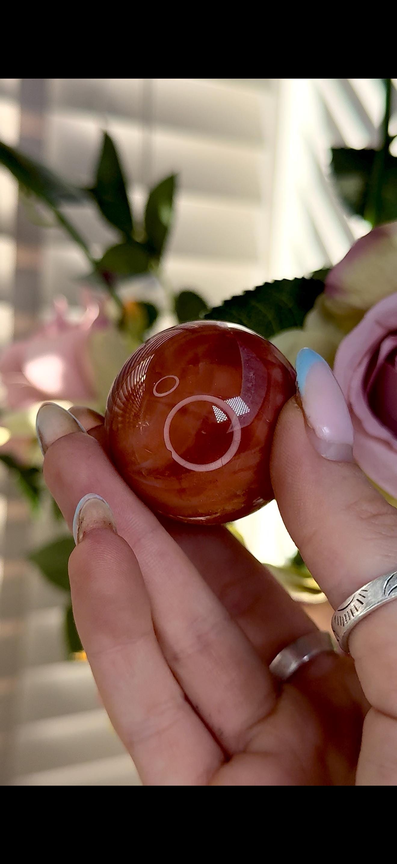 High quality, small red agate, carnelian sphere in orange/red tones