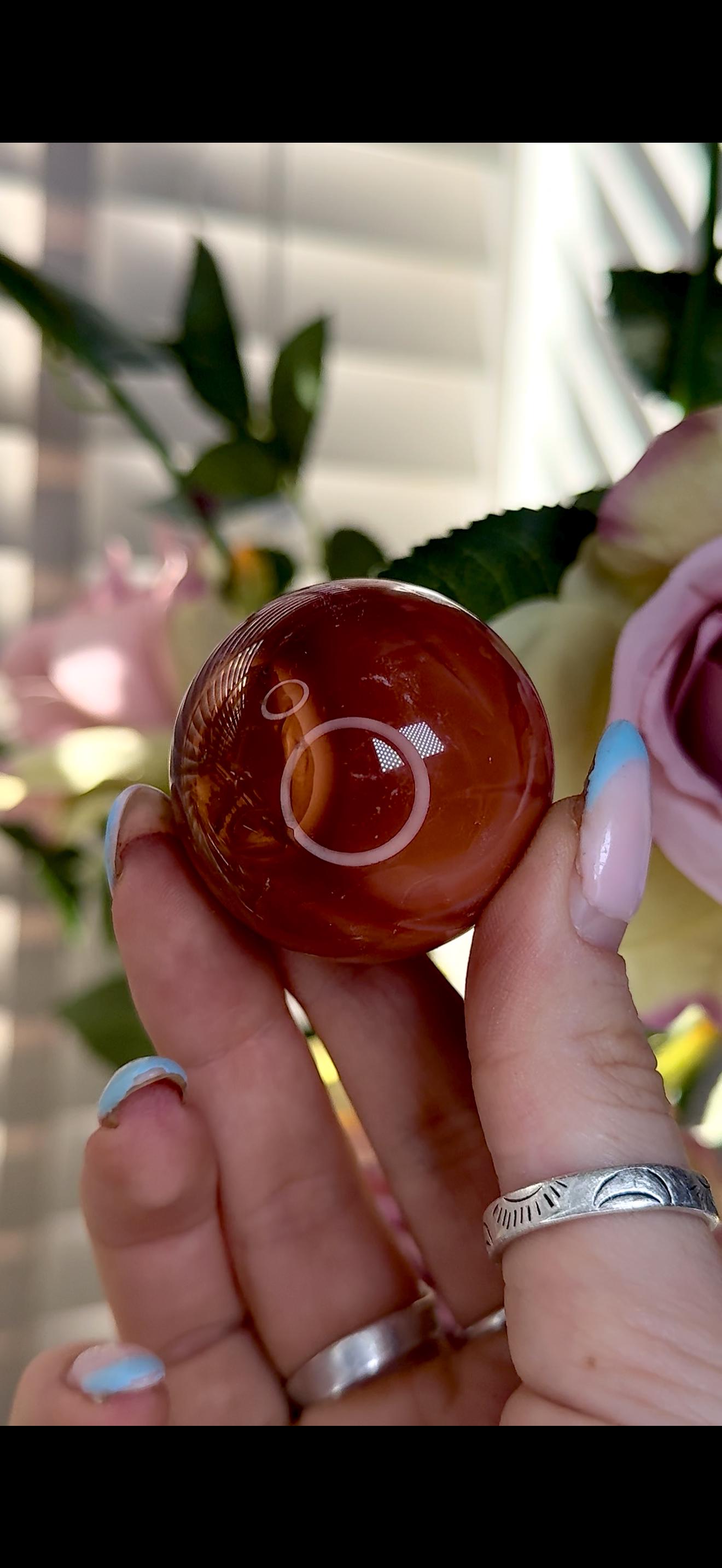 High quality, small red agate, carnelian sphere in orange/red tones